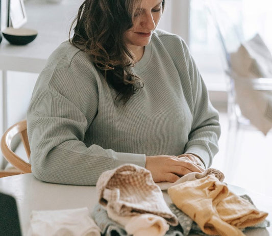 mom folding clothes - home organizing tips to prevent clutter