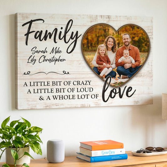 Personalized family photo canvas hanging above a sideboard, with a family of four in an autumn park inside a heart, the names Sarah Mike Lily Christopher, and the words Family, a little bit of crazy, a little bit of loud and a whole lot of love on a whitewashed wood background