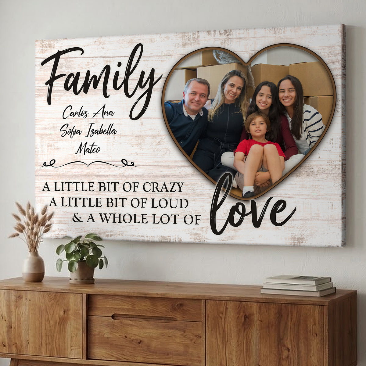 Custom family photo canvas with a family of five in a heart, family names and Family love wording, hanging above a wooden sideboard