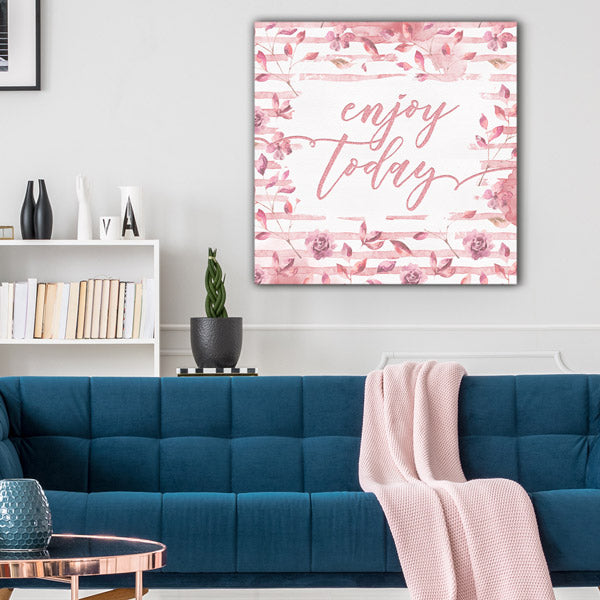 living room with blue sofa and pink throw blanket - pink floral wall art with "enjoy today" print - GearDen